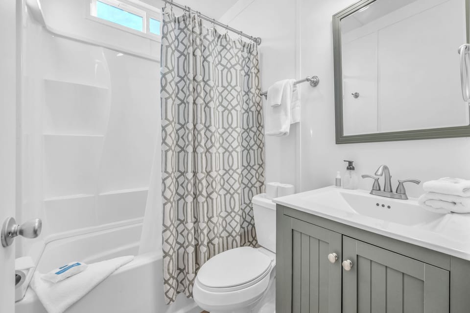 Step into your beautifully appointed bathroom with a sleek vanity, fresh towels, and modern fixtures for your comfort.
