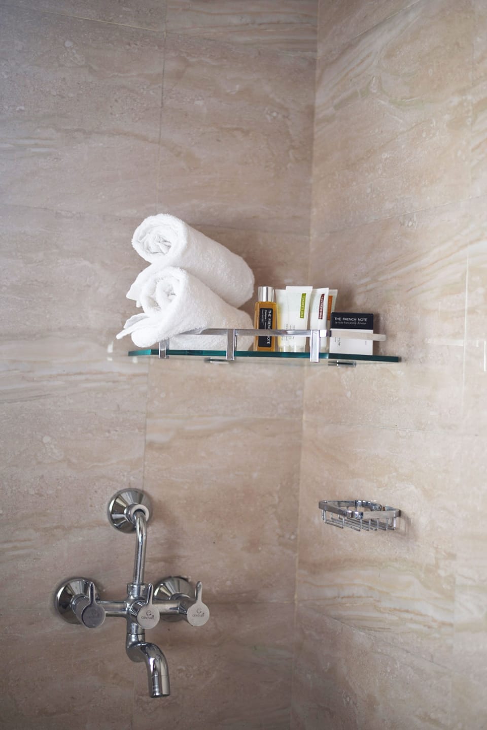 Shower, rainfall showerhead, slippers, towels