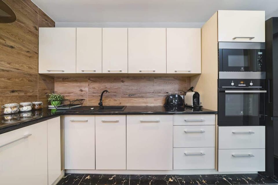 Kitchenette with oven and refrigerator. 