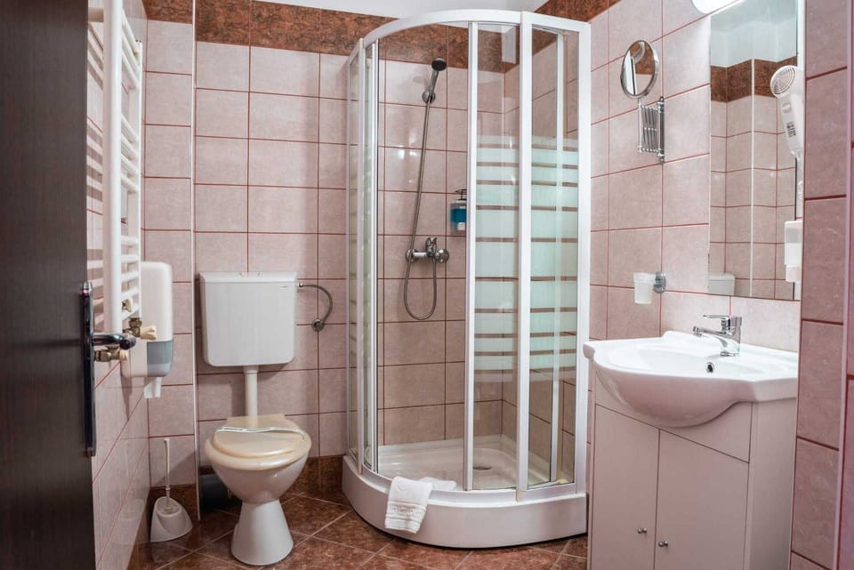 Shower, designer toiletries, hair dryer, towels