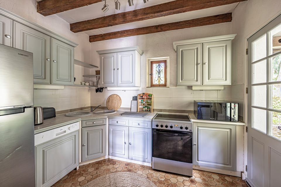 Inside kitchen with fridge/freezer, dishwasher, oven, hob, and microwave