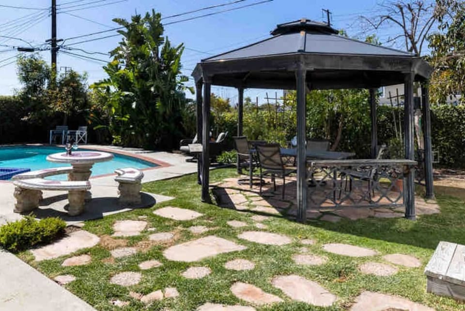 Enjoy the breeze and shaded comfort in this cozy outdoor nook.