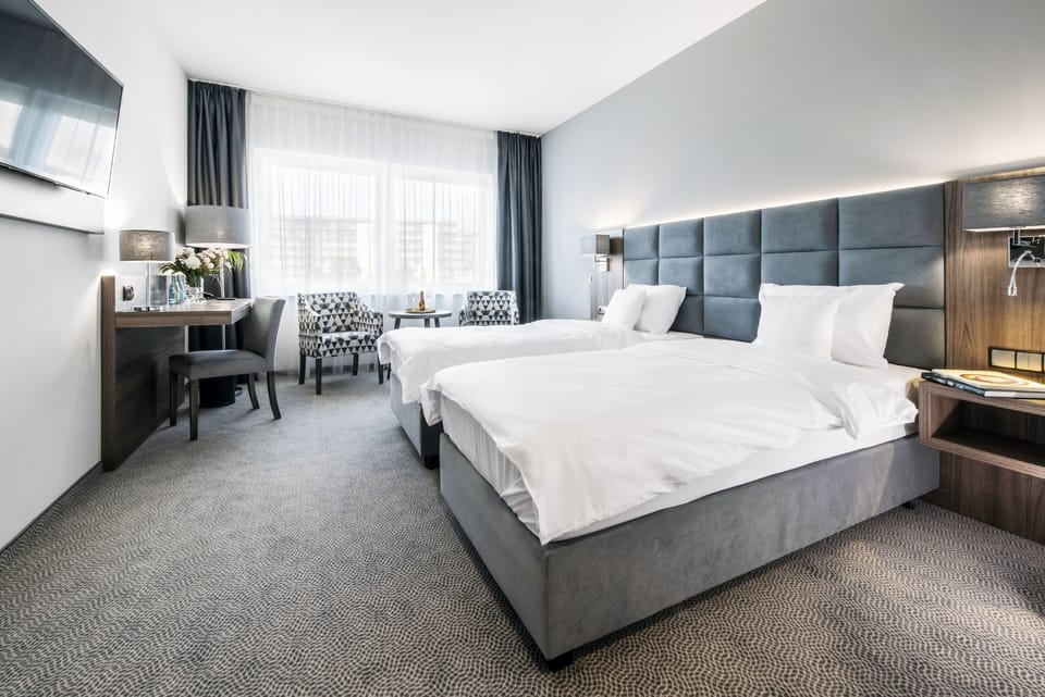 Standard Twin Room | Minibar, desk, laptop workspace, blackout drapes