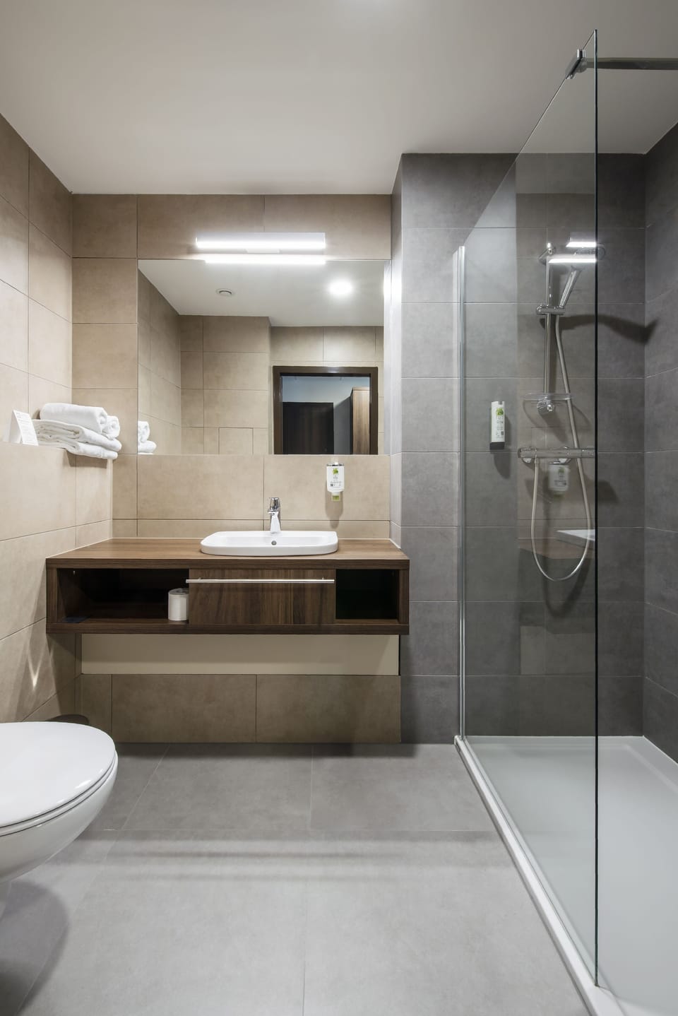 Shower, designer toiletries, hair dryer, towels