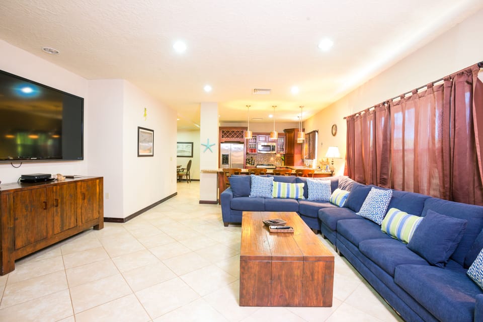The living room is open and spacious and flows into the kitchen area