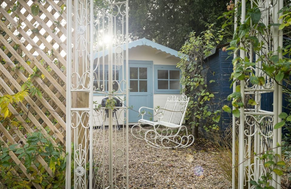The garden features a pretty summer house and charcoal barbecue, perfect for sunny days
