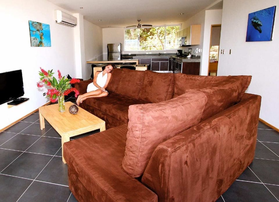 The living room - includes living area with chaise lounge, dining area with seating for six, breakfast nook, and kitchen.