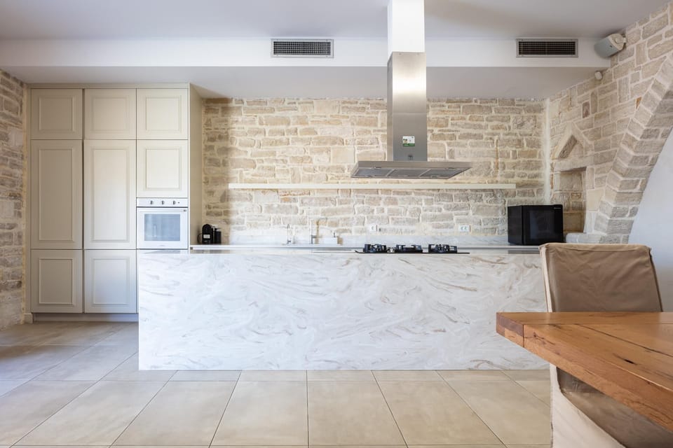 The kitchen is fully equipped and features a large dining table.