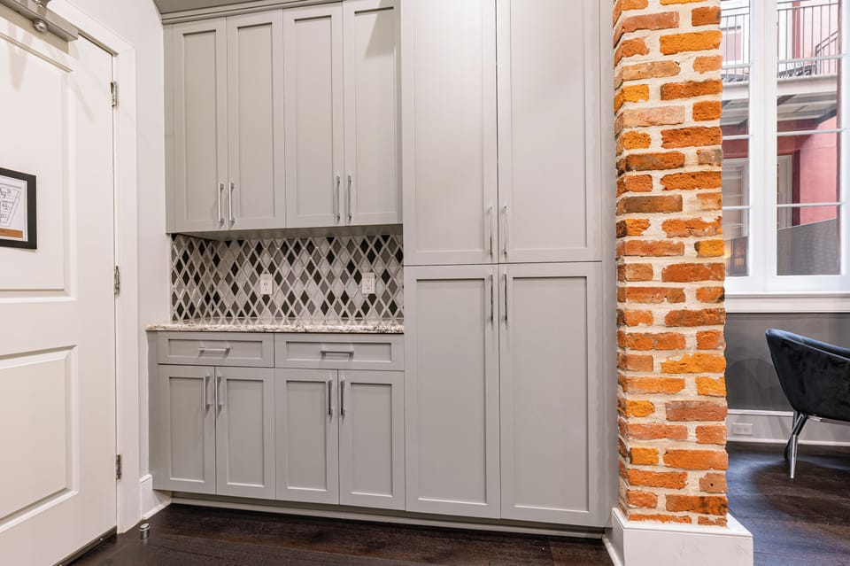 Galley-style, fully equipped kitchen with an open flow to the living/dining area. Stocked with essentials from mixing bowls to wine glasses, featuring stainless steel appliances, stone countertops, and a tile backsplash for a luxurious feel!