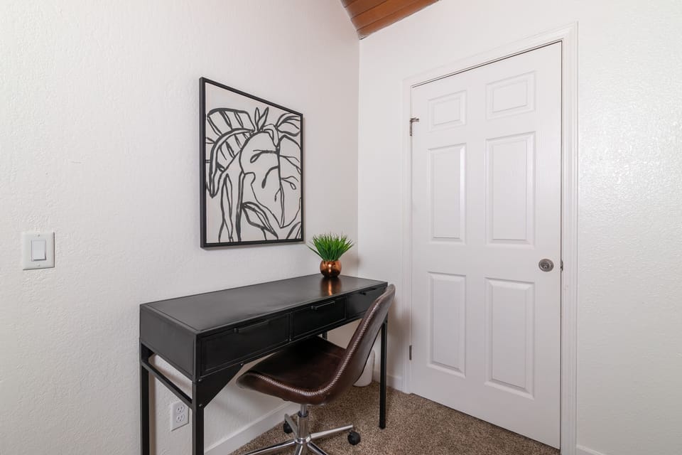 Upstairs 5th bedroom with office desk and chair.