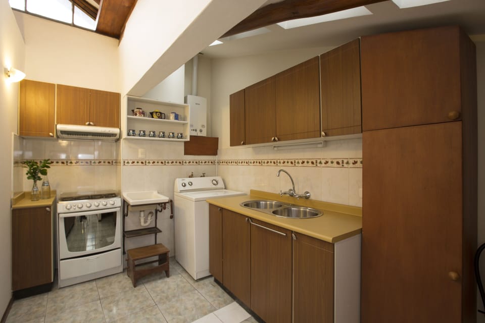 Full equipped kitchen with stand stove, fridge, washer