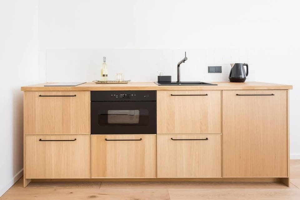Practically equipped kitchen area with kettle, toaster, and microwave.
