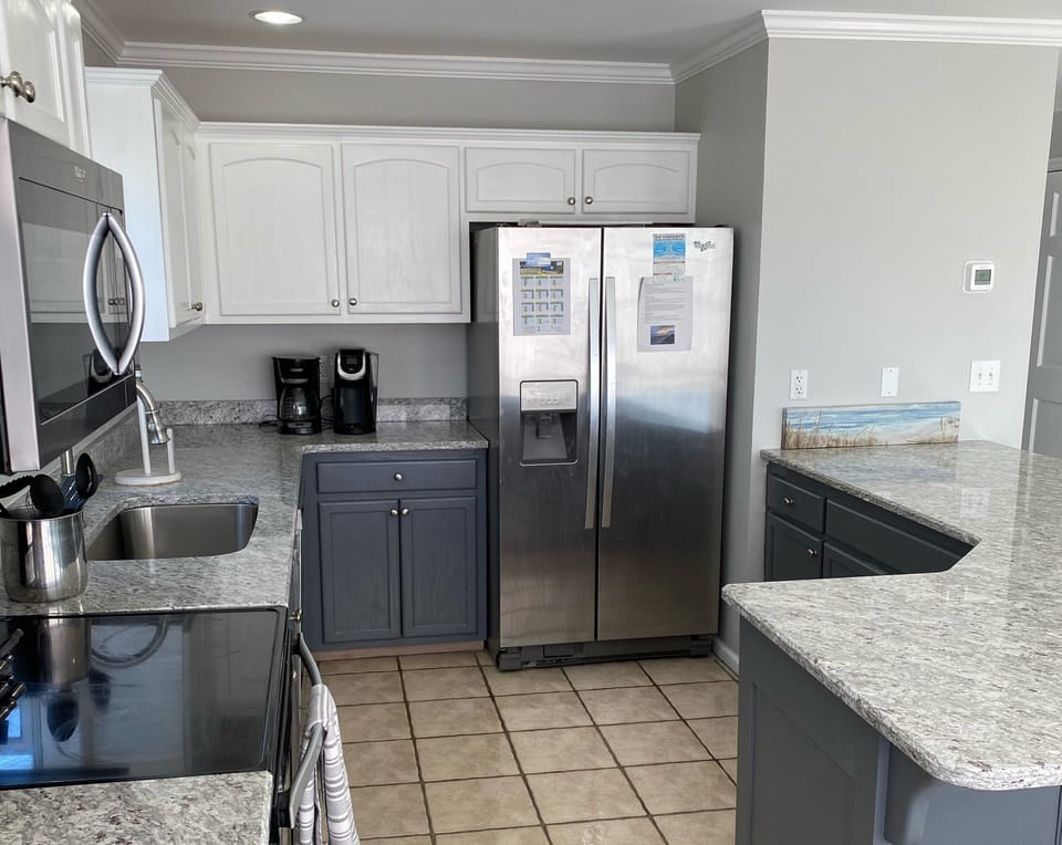 Updated kitchen, featuring new granite countertops.
