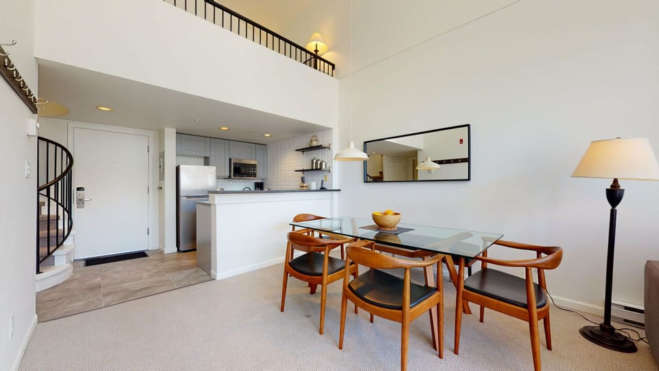 A modern table seats four for meals or game nights.