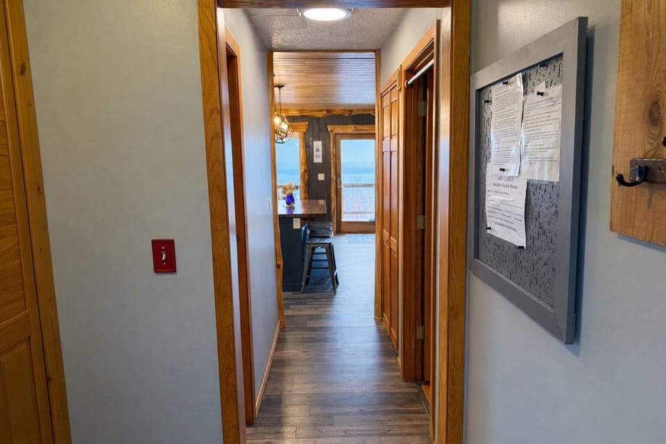 Hallway view with a bathroom on the left, bedroom on the right, and the bright main living space straight ahead. Easy, intuitive layout that makes settling in a breeze.