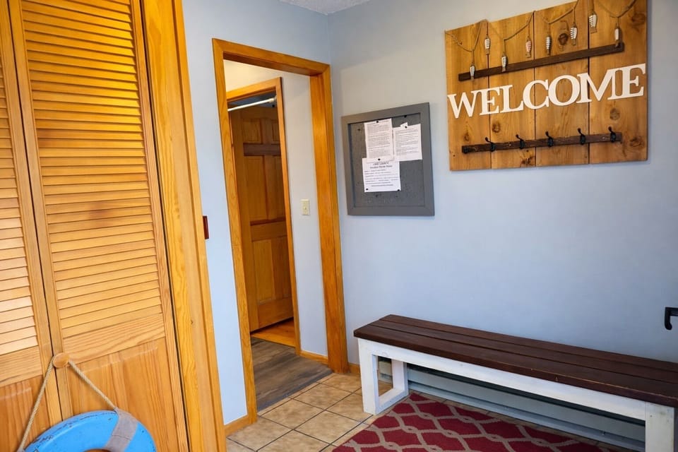 Entryway with a bench and handy hooks, drop your gear and settle in. This practical space welcomes you as you step inside.