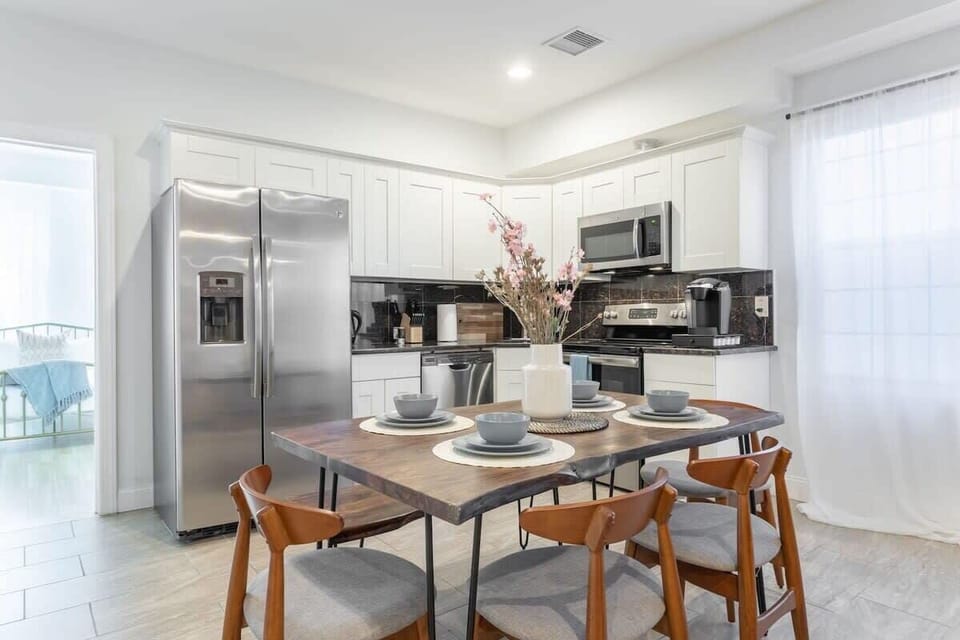 Spacious dining area + stainless steel kitchen appliances.