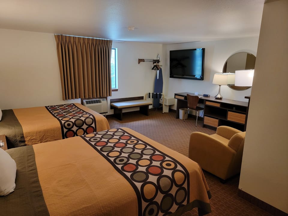 Suite, 2 Queen Beds | Living area | 55-inch flat-screen TV with cable channels, TV