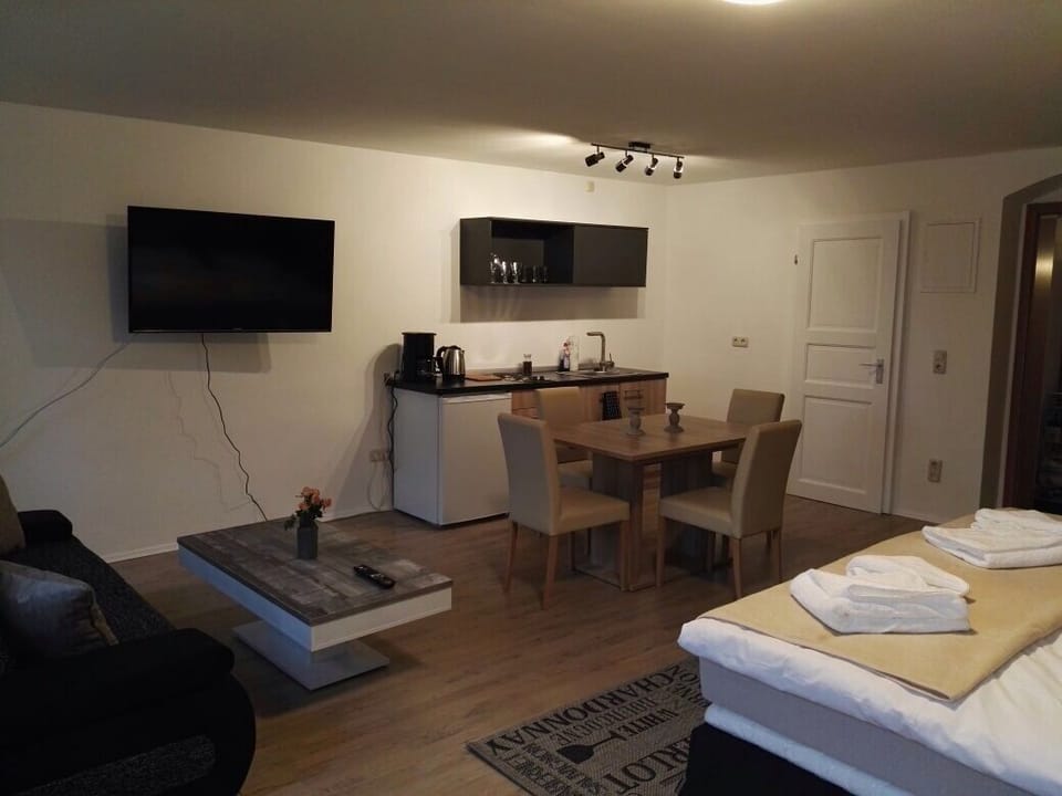 Quadruple Room (Büttner 3) | Living area | Flat-screen TV