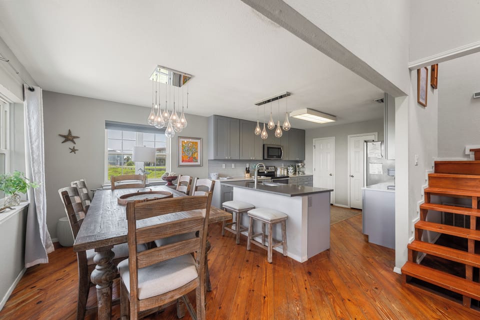 You'll love gathering in this open, light-filled dining and kitchen space with warm wood floors, modern fixtures, and everything you need to prepare meals and share stories together.
