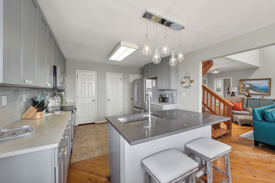 Step into your beautifully updated kitchen with a spacious island and modern finishes, where cooking becomes part of the vacation experience as the open layout flows seamlessly into the living area.