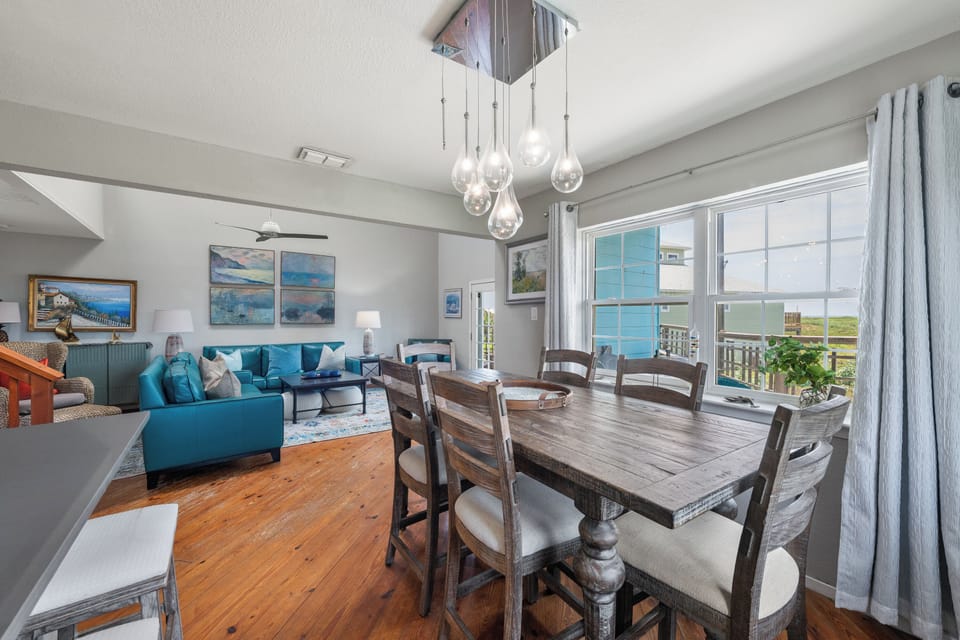 Gather around the rustic farmhouse table and enjoy meals with expansive ocean vistas framing every moment. Soft natural light floods the open layout, blending your dining and living spaces into one inviting retreat.