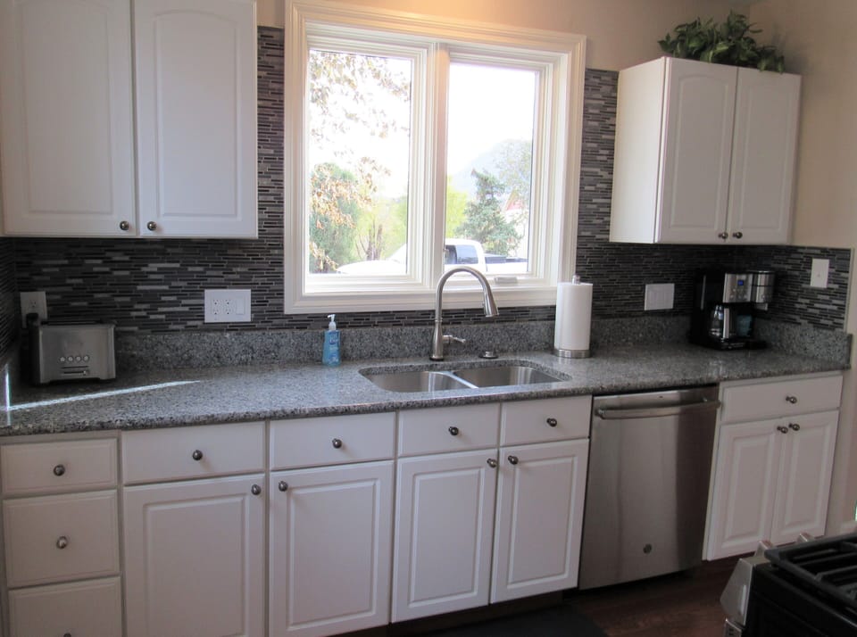 Kitchen with new stainless steel appliances.