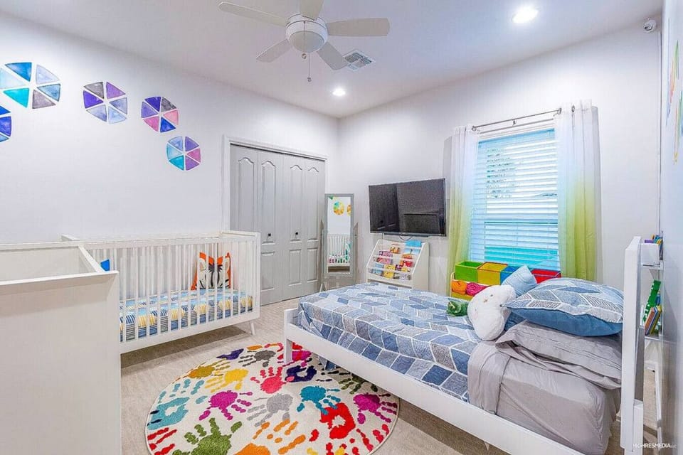 [Bedroom 4] Kids room with a single twin bed, a toddler bed, and a crib