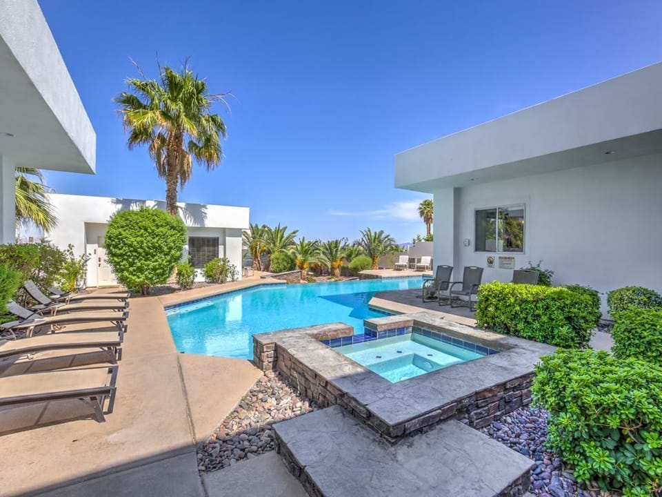 Large infinity edge pool with spa and plenty of lounge chairs