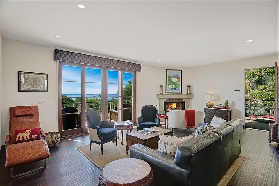 Living room with fireplace, open floor plan and high end furnishings.