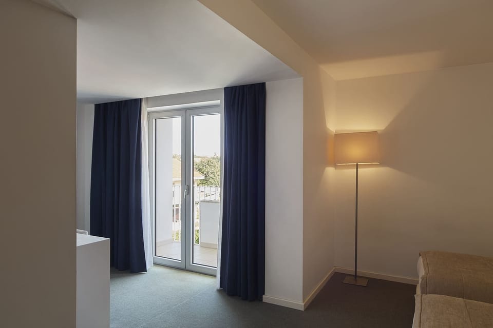 Double or Twin Room (City With Balcony) | Memory foam beds, minibar, in-room safe, individually decorated