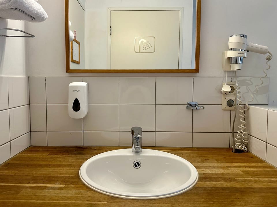 Basic Single Room, 1 Twin Bed (private shower) | Bathroom | Shower, hair dryer, towels