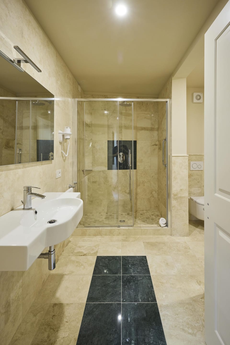 Designer toiletries, hair dryer, slippers, bidet