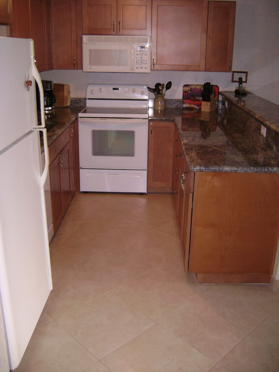 Upgraded kitchen with maple cupboards and granite counters.