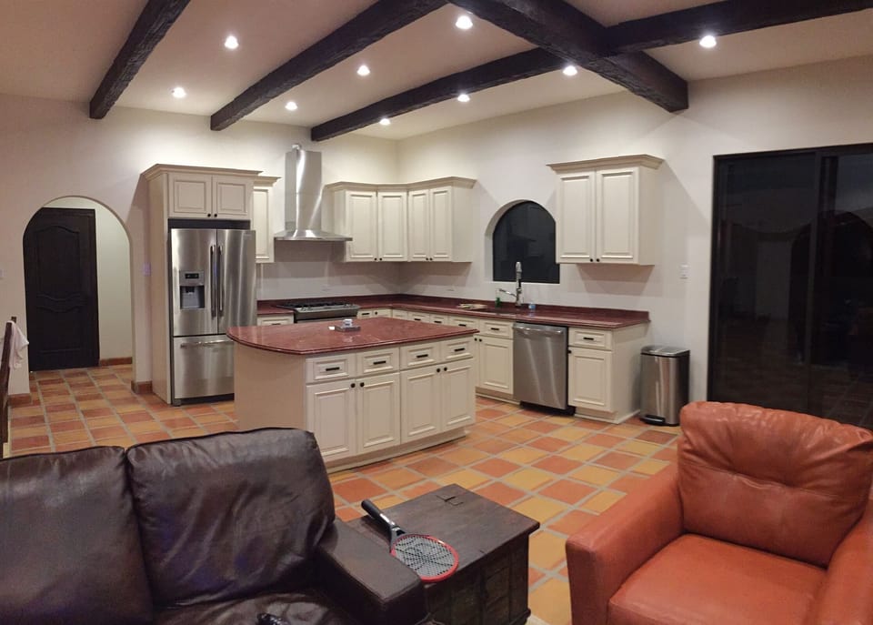view from tv area at large kitchen with lots of cooking space