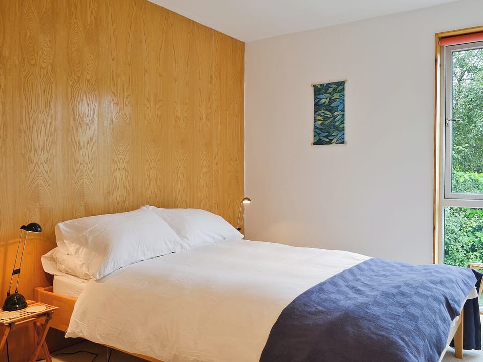 5ft double bed in wood-panelled bedroom | West Bothy at Cluain Ghrianach, Laga, near Acharacle
