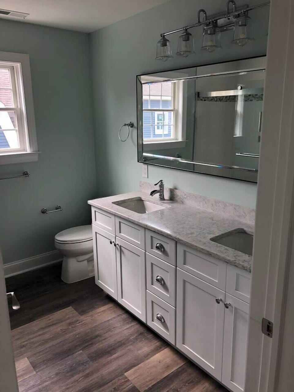 2nd floor hallway bathroom with two sinks, toilet and large shower