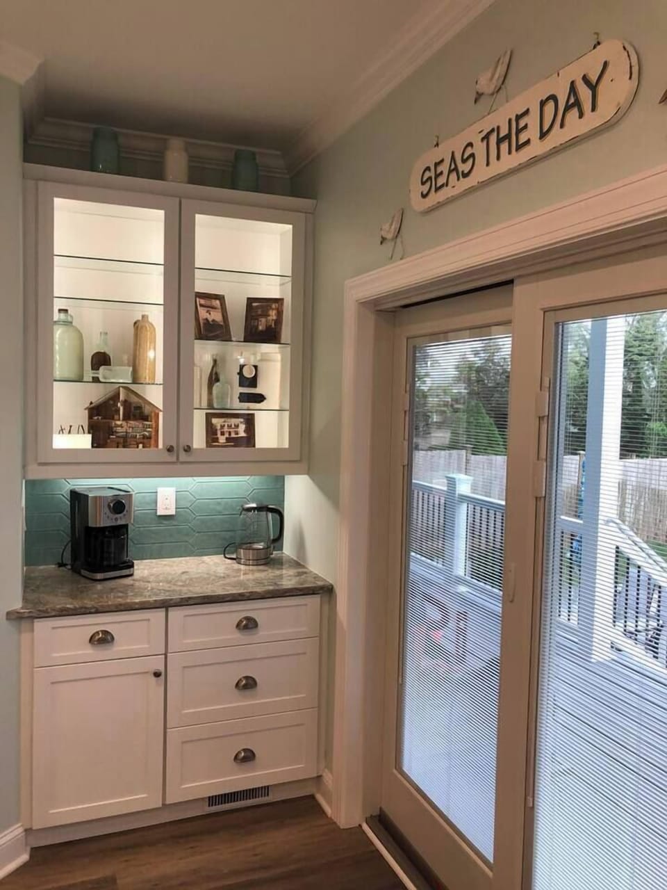 Museum showcasing some artifacts from the original house along with the beverage center and sliding door to back deck.