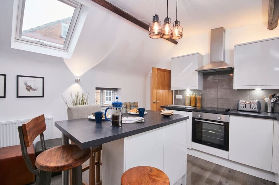 Fully-equipped fitted kitchen with breakfast bar seating area