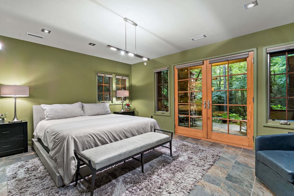 Lower-level bedroom with King bed, Smart TV, en suite bath, and private entrance.