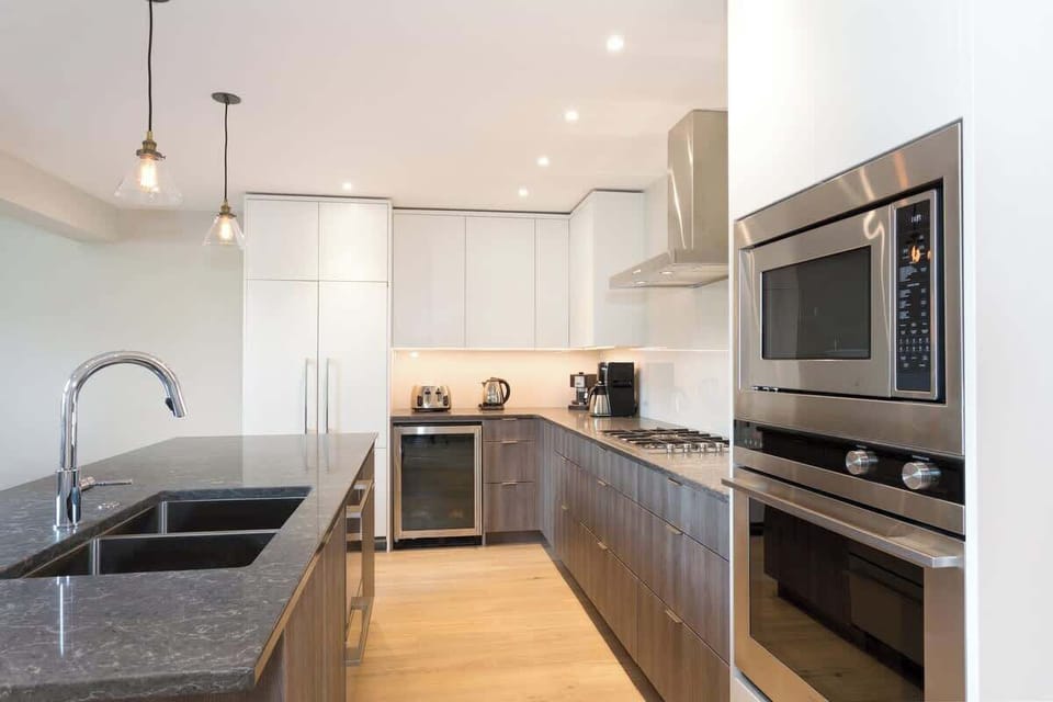 - Modern kitchen design with marble counters and built-in oven  
- Fully equipped space for cooking and entertaining with ease  
- Blends sleek style and functionality for every guest’s comfort  