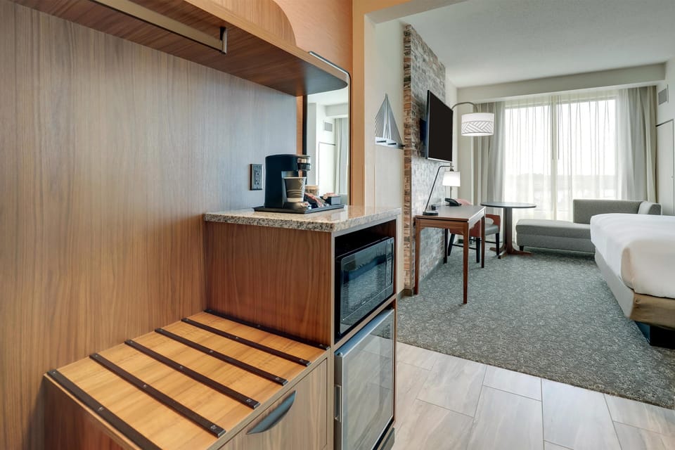 Premium bedding, desk, laptop workspace, blackout drapes