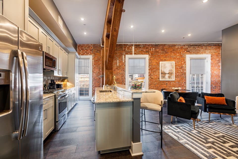 Cook and dine easily in the fully stocked kitchen, equipped with all stainless steel appliances, gas range, basic cookware, and a dining area for a comfortable meal at home. Entertain at the bar with seating for four.