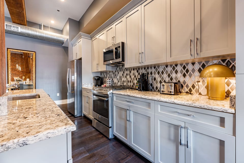 Cook and dine easily in the fully stocked kitchen, equipped with all stainless steel appliances, gas range, basic cookware, and a dining area for a comfortable meal at home. Entertain at the bar with seating for four.