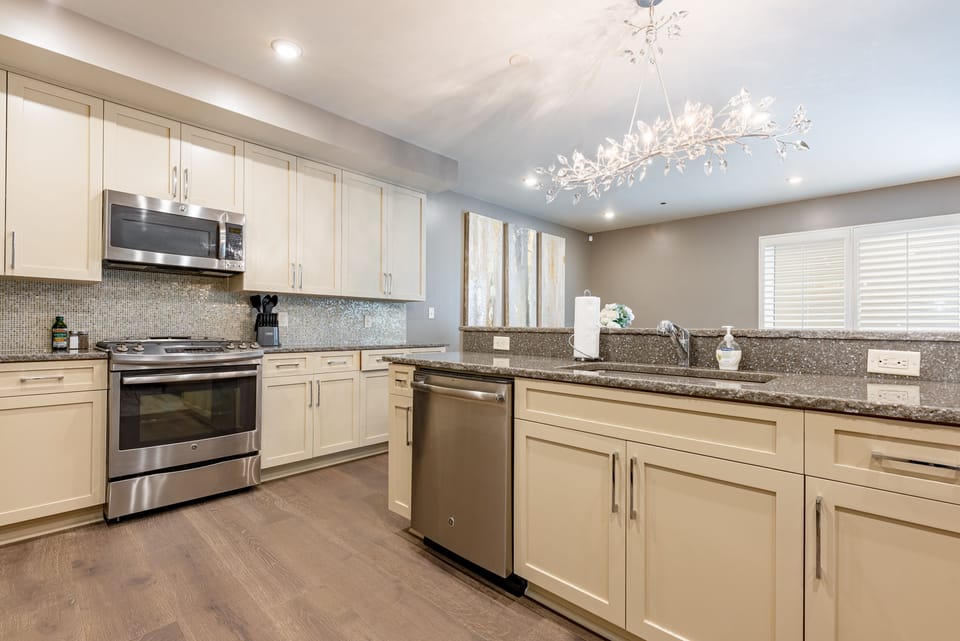Cook and dine easily in the fully stocked kitchen, equipped with all stainless steel appliances, gas range, basic cookware, and a dining area for a comfortable meal at home. Entertain at the island with seating for three.