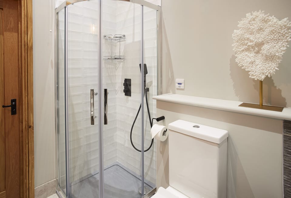 En-suite bathroom to bedroom one with bath and separate shower