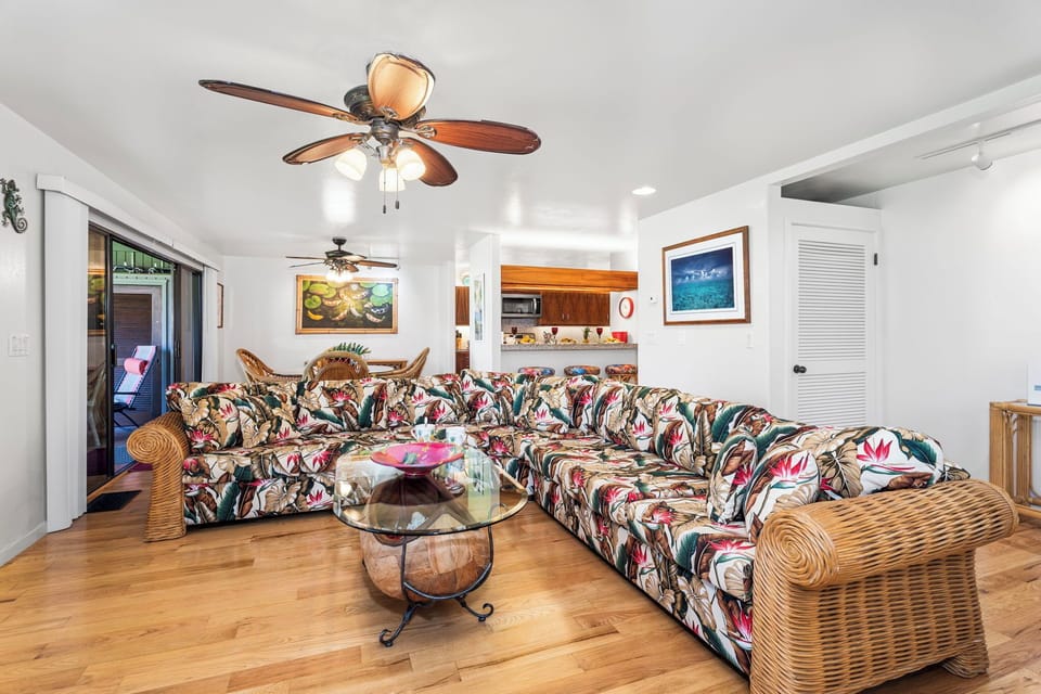 Relax in your tropical-themed living room with spacious sectional seating, perfect for gathering with loved ones after island adventures.