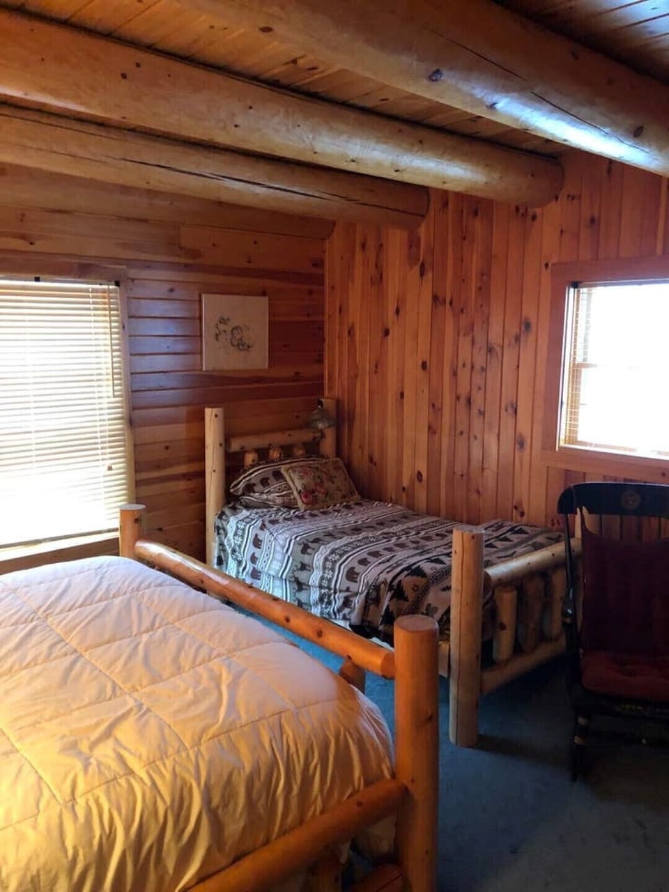 First floor bedroom with queen bed and additional child bed.