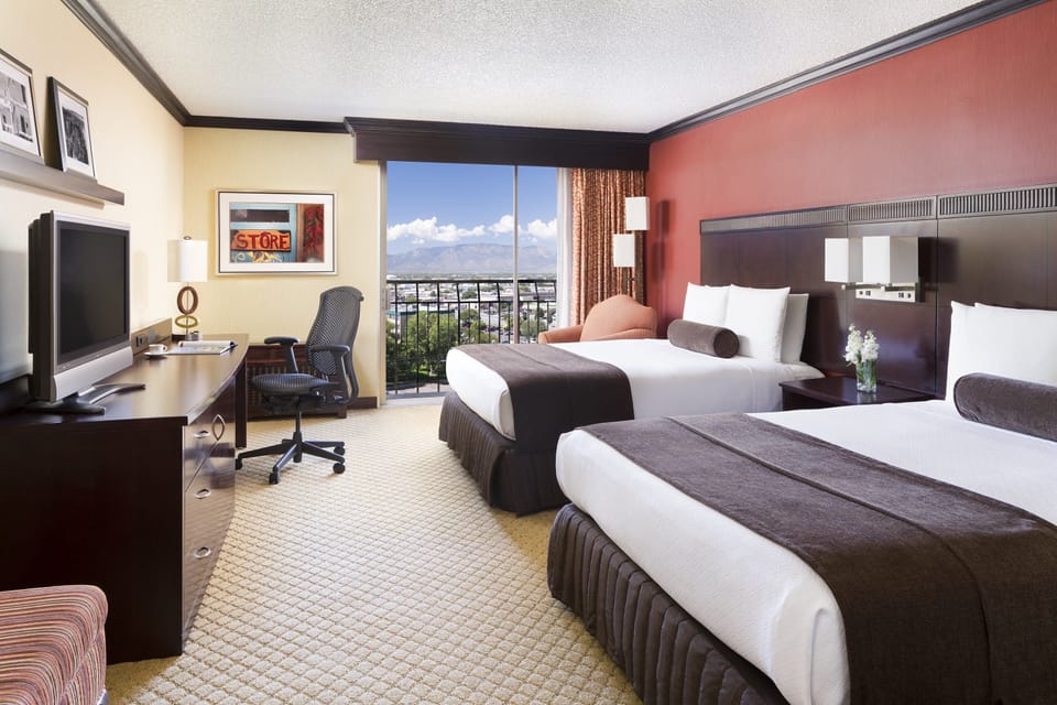 Premium bedding, desk, laptop workspace, blackout drapes