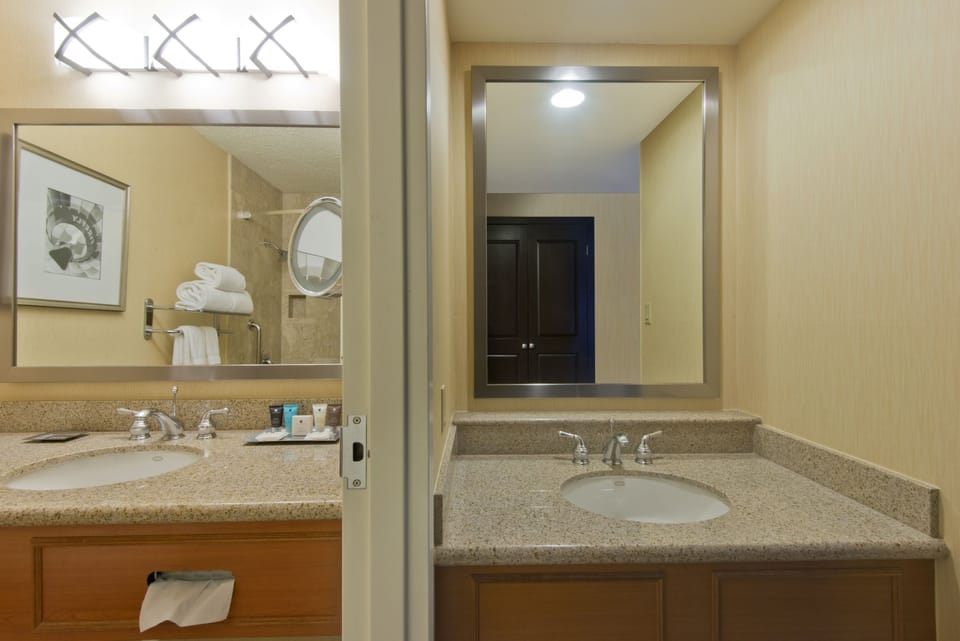 Premium bedding, desk, laptop workspace, blackout drapes